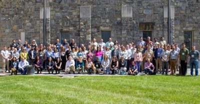 This is a group photo of all the conference attendees in front of the Hokie stone building of the Inn.